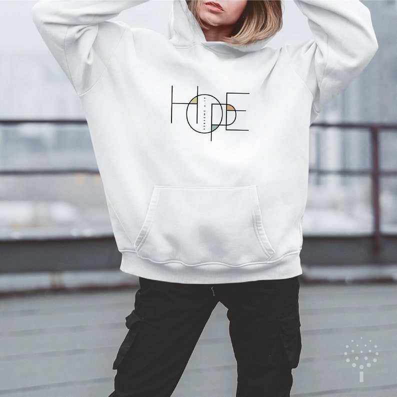 May include: White hooded sweatshirt with a black graphic of the word "HOPE" in a geometric design with a circle in the centre.
