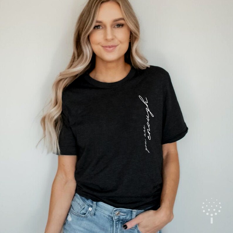 May include: A black t-shirt with the text "you are enough" written vertically on the left side of the shirt.