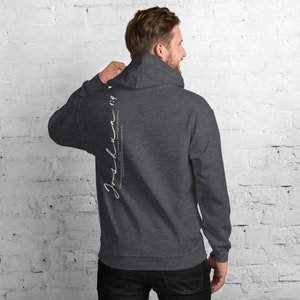 May include: A dark gray hooded sweatshirt with the text "Joshua 1:9" printed on the back in white.
