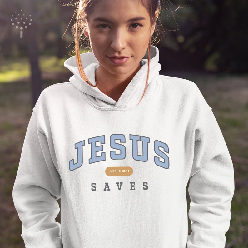 May include: White hoodie with blue text that reads "JESUS SAVES" and "ACTS 18:10-21" in a smaller font.