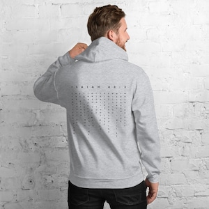 May include: Grey hooded sweatshirt with a black word search puzzle on the back. The puzzle features the text "ISAIAH 43:2".