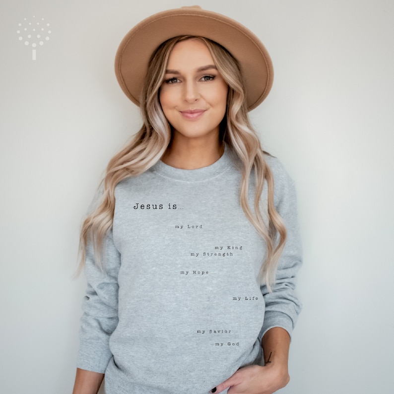 May include: A gray sweatshirt with the text "Jesus is... my Lord, my King, my Strength, my Hope, my Life, my Savior, my God" printed on the front.