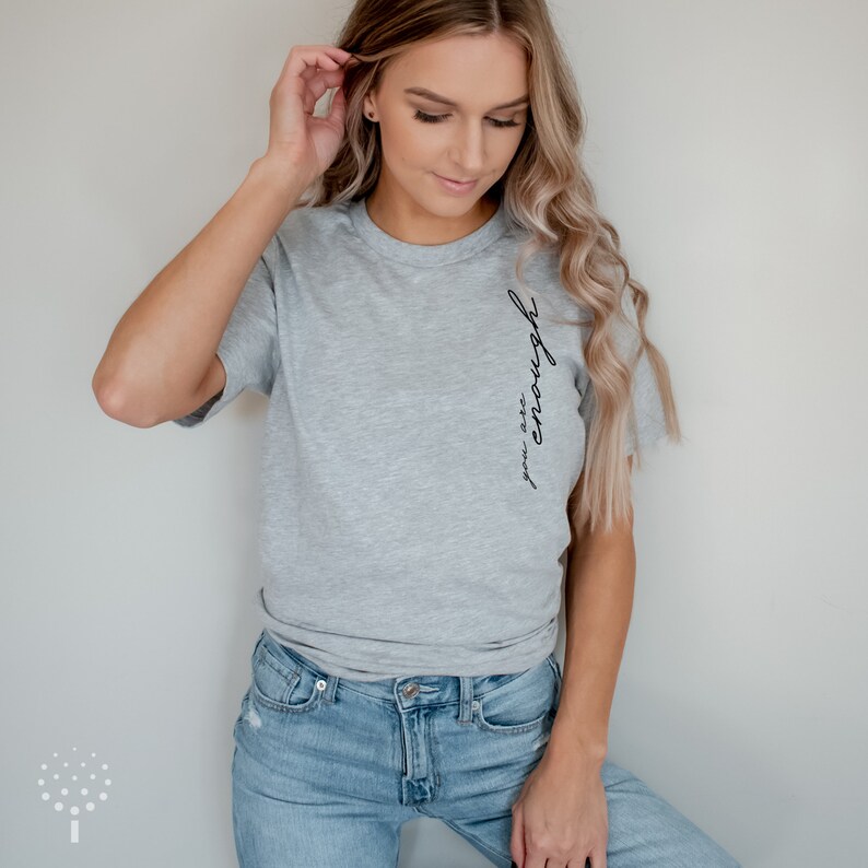 May include: A gray t-shirt with the text "you are enough" written in black on the side.