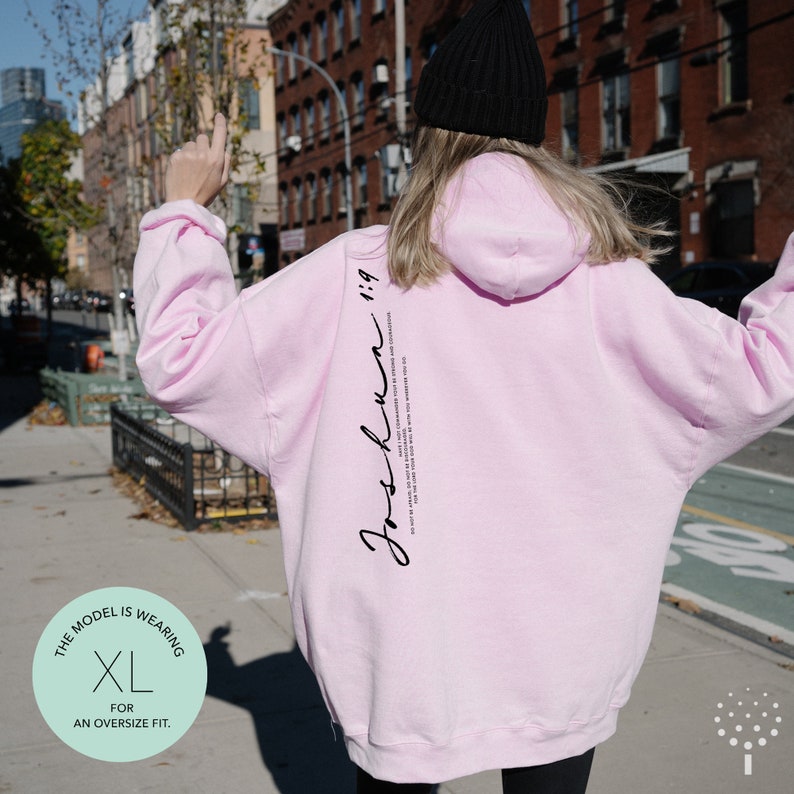 May include: Pink oversized hoodie with the text "Just Run 1:19" printed on the back. The model is wearing a size XL.