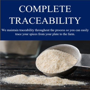 May include: A close-up of a metal spoon filled with a white powder, with a small amount of powder spilled on a wooden surface. The text "COMPLETE TRACEABILITY" is displayed above the spoon. The text below the spoon reads "We maintain traceability throughout the process so you can easily trace your spices from your plate to the farm."