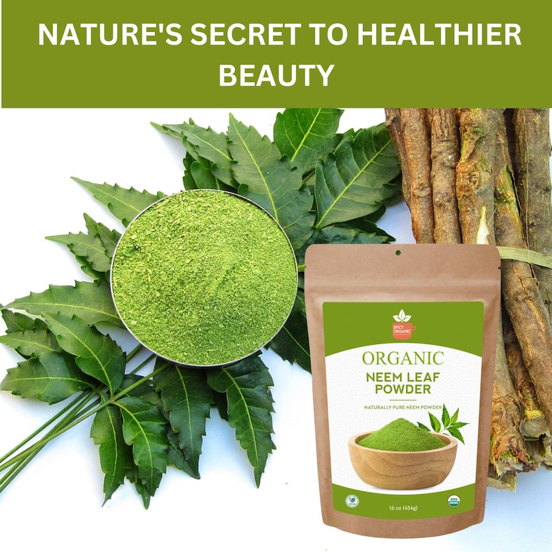 May include: A brown paper bag with a label that reads "Organic Neem Leaf Powder" and a picture of a bowl of green powder. The bag is sitting on a white surface with green leaves and brown sticks.