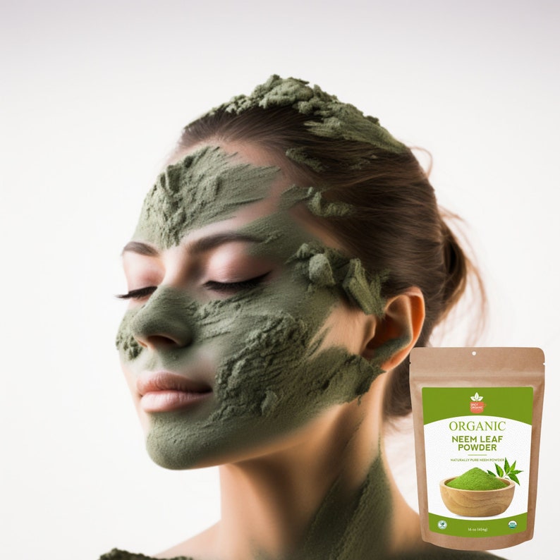 May include: A woman with a green face mask made from neem leaf powder. The product packaging is visible in the background, featuring the text "Organic Neem Leaf Powder" and a small image of a neem leaf.