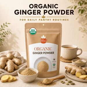 May include: A brown pouch of Organic Ginger Powder with a white label featuring the text Organic Ginger Powder, USDA Organic, and Spicy Organic. The pouch is surrounded by fresh ginger roots, a bowl of ginger powder, a wooden spoon, and a mug.