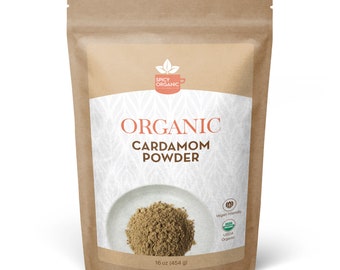 May include: A brown paper bag with a white label that says "Organic Cardamom Powder" and "Spicy Organic" in a logo. The bag contains 16 ounces (454 grams) of ground cardamom powder. The label also includes USDA Organic and Vegan Friendly logos.