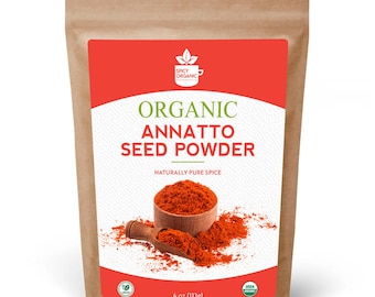 May include: A brown paper bag with a label that says "Organic Annatto Seed Powder" in white text on a red background. The label also includes a small green leaf logo and the text "Naturally Pure Spice". The bag contains 4 ounces (113 grams) of annatto seed powder.