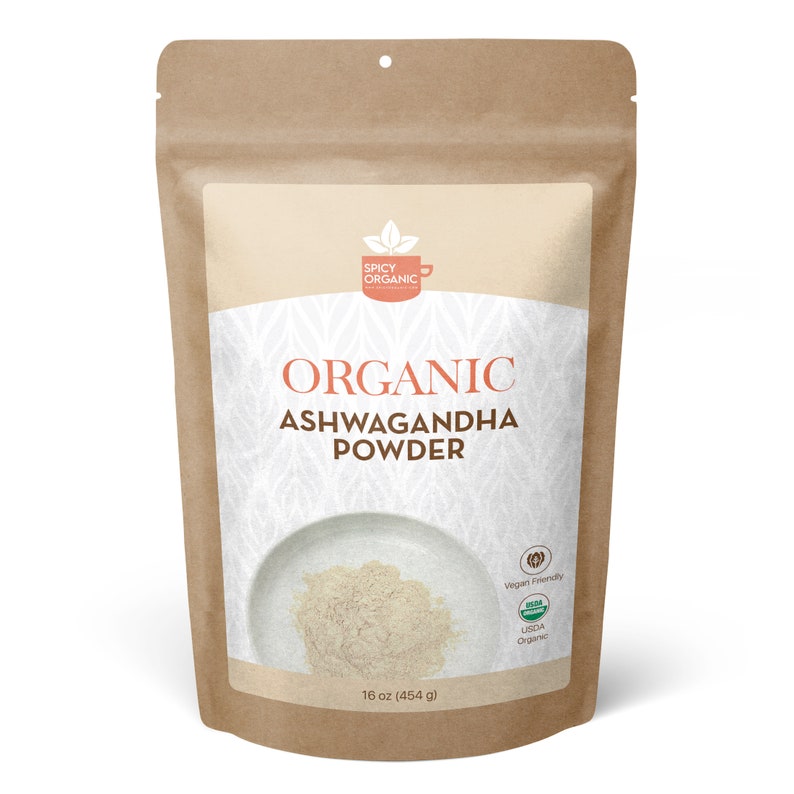 May include: A brown paper bag with a white label that says "Organic Ashwagandha Powder" and has a picture of a bowl of powder. The label also says "Spicy Organic" and has a USDA Organic seal.