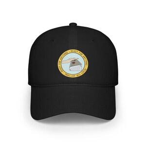 May include: Black baseball cap with a yellow circle and the text "Ready for Anything - Ready for Anything" around a cartoon hand pressing a red button on a grey box.