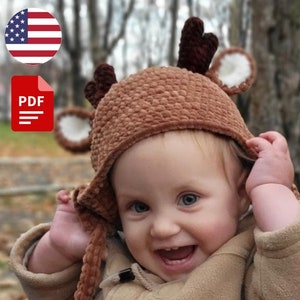May include: A PDF pattern for crocheting a brown deer hat with floppy ears and antlers. The hat is worn by a smiling baby in a brown jacket.