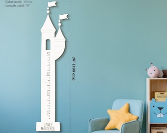 May include: White wooden castle-shaped growth chart with a ruler measuring up to 78 inches. The chart is personalized with the name "JAMES MACKENZIE".