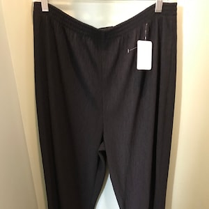 May include: Dark gray ribbed knit pants with a wide leg and a drawstring waist.