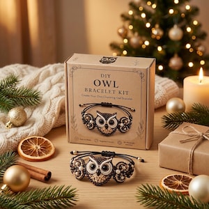 May include: A cardboard box labeled DIY OWL BRACELET KIT with an illustration of a beaded owl bracelet, accompanied by a finished black cord bracelet featuring a central beaded owl motif with white, brown, and black beads on a wooden surface.