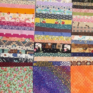 May include: A collection of fabric squares in various colors and patterns, including floral, geometric, and polka dot designs. The squares are arranged in rows and columns, creating a patchwork effect.