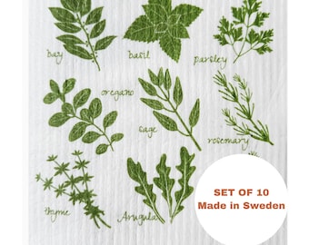 May include: A white kitchen cloth featuring green illustrations of various herbs, including bay, basil, parsley, oregano, sage, rosemary, thyme, and arugula. The text "SET OF 10 Made in Sweden" is also visible.