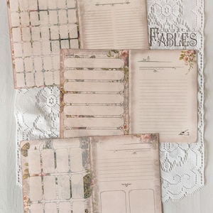 May include: Set of four printable journal pages with a vintage aesthetic. The pages feature floral and butterfly designs, lined sections, and blank boxes for journaling.
