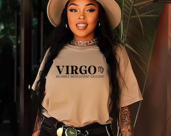 May include: A tan t-shirt with the text "VIRGO ♍ RELIABLE INTELLIGENT DILIGENT" printed in black. The model is wearing a brown hat and black pants.
