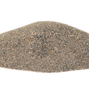 May include: A pile of gray sand with a slightly brown tint. The sand is fine-grained and appears to be dry.