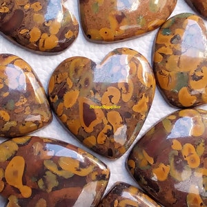 May include: A collection of polished heart-shaped stones with a brown, yellow, and green marbled pattern. The stones are smooth and shiny, and they have a unique and beautiful appearance.