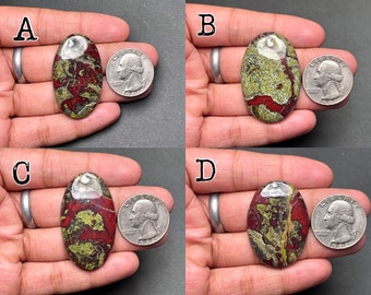 May include: Four oval-shaped, polished, green, red, and white jasper cabochons, each approximately the size of a US quarter.