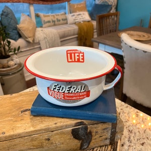 May include: White enamelware bowl with a red rim and a red and white logo that says "Federal Vogue Enameled Ware" with the text "Titanium added for extra life" and "Advertised in Life" in red.
