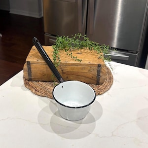 May include: A rustic wooden sign with the text "Welcome to our home" in white lettering. The sign features a distressed finish and a simple, inviting design, perfect for a front porch or entryway.