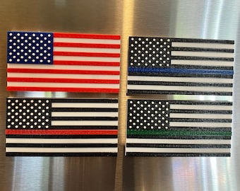 May include: Four American flag magnets with thin colored stripes added to represent different support groups. The top left magnet is a traditional American flag. The top right magnet has a thin blue stripe. The bottom left magnet has a thin red stripe. The bottom right magnet has a thin green stripe.