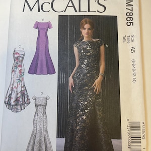 May include: McCall's sewing pattern M7865 featuring illustrations of formal gowns. The pattern includes a floor-length black gown with gold floral accents, a purple gown, and two other dress designs. Size A5 (6-8-10-12-14).