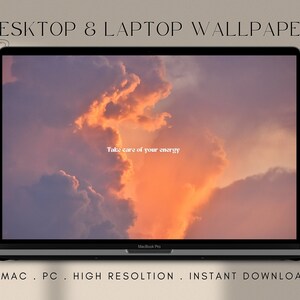 May include: A laptop computer displaying a desktop wallpaper with a sunset sky and the text "Take care of your energy".