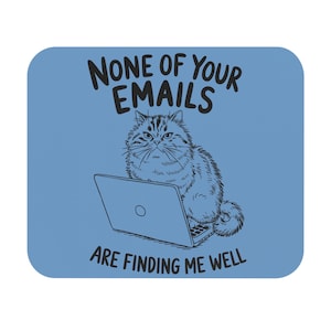 May include: A blue mousepad with a cat illustration using a laptop. The text reads "NONE OF YOUR EMAILS ARE FINDING ME WELL" in black. The cat has a grumpy expression.