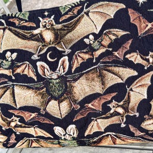 close up of bat woven tapestry weekender bag with jacquard texture