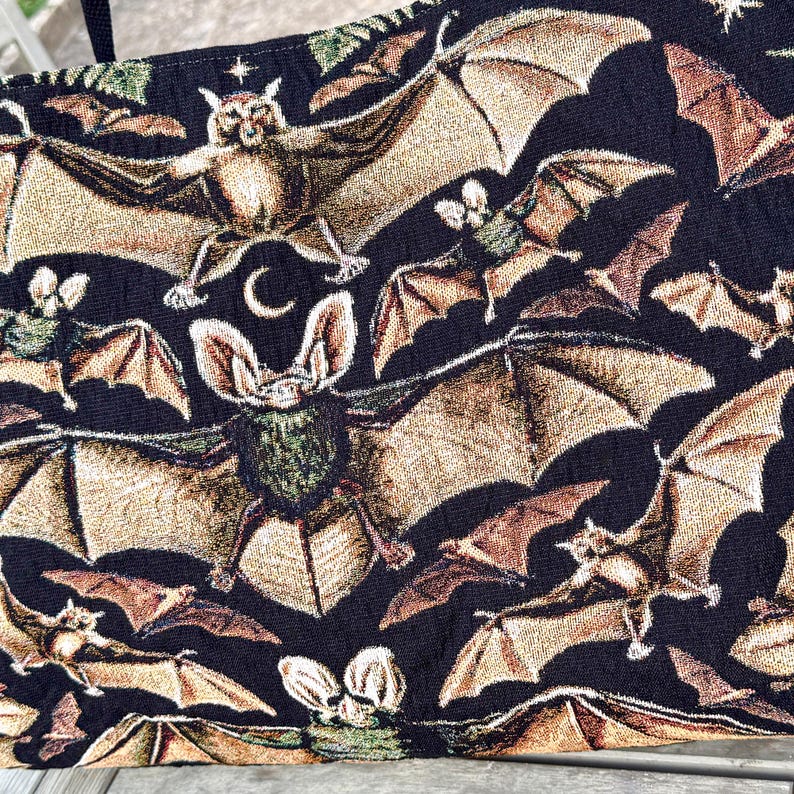 close up of bat woven tapestry weekender bag with jacquard texture