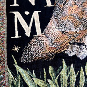 With a medieval tapestry aesthetic, this Barn Owl woven blanket with fringe has a dark academia decor aesthetic. The latin phrase Natura In Minima Maxima in vintage font surrounding the large Barn owl is perfect for the nature lover in your life.