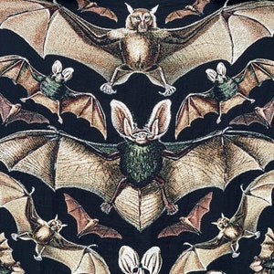 Halloween woven blanket with bats on a black background.