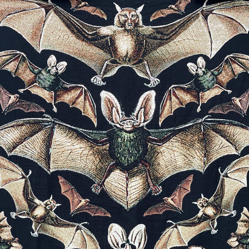 Halloween woven blanket with bats on a black background.