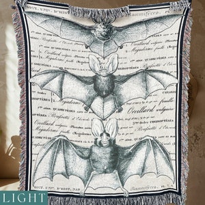 The three large bats on this all cotton woven blanket are either deep grey black or a lighter grey with a slight slate blue hue.