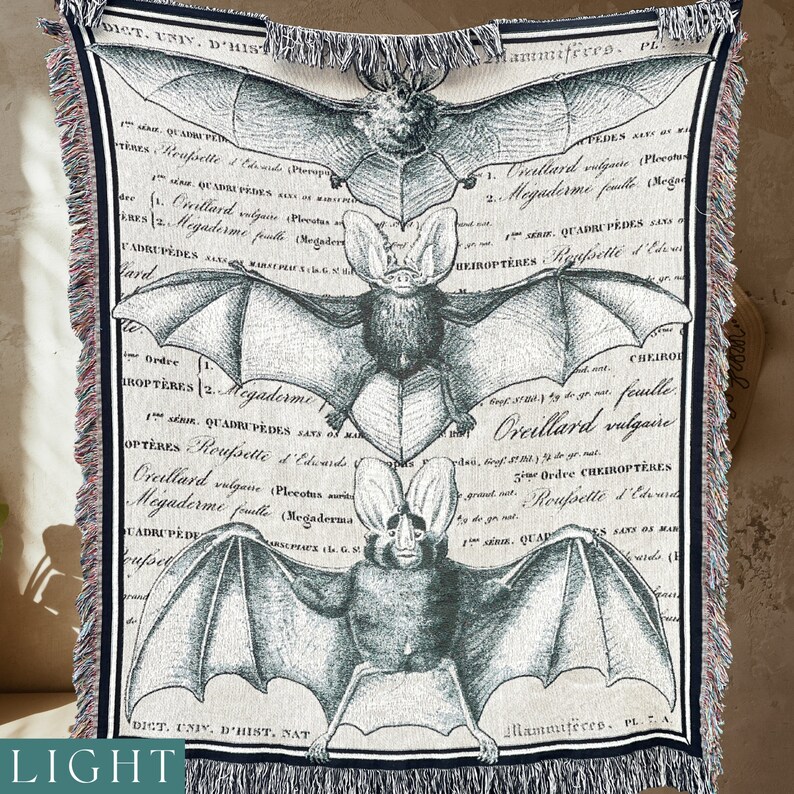 The three large bats on this all cotton woven blanket are either deep grey black or a lighter grey with a slight slate blue hue.