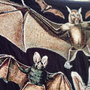 Halloween Blanket with neutral colored woven bats on a black background.