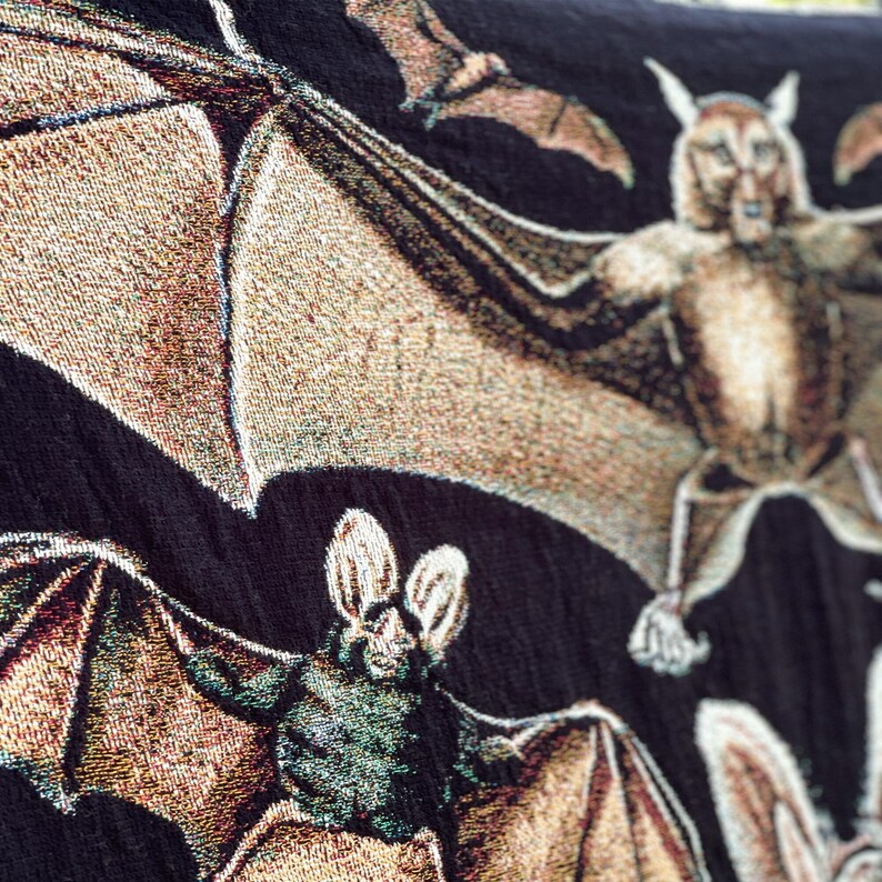 Halloween Blanket with neutral colored woven bats on a black background.