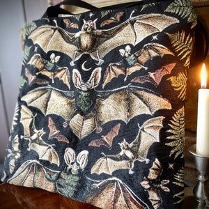 Lovers of goth clothing, goblincore clothing, forestcore, vulture culture and dark academia will all adore this vintage bag woven tote bag. Perfect as a book bag, this woven tapestry tote bag is approximately 17 inches wide by 18 inches tall.