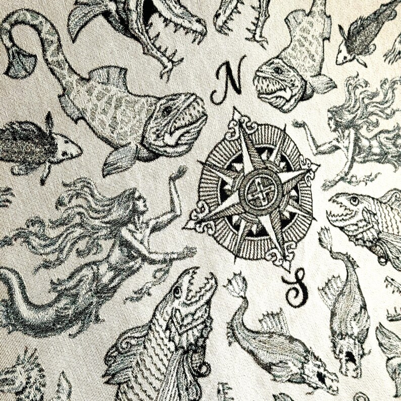 Vintage sea creature / mystical sea creature woven blanket. Deep sea mystical sea creatures with mermaids & and central compass in a vintage pirate map scene.