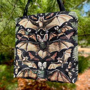 This vintage Halloween bat tote bag is woven, not printed. This woven tapestry bat bag has a black inner liner with the exterior being a tightly woven combination of cotton and polyester to make a durable tote bag. The vintage bats are warm neutrals.
