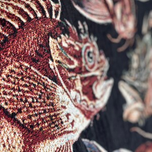 Vintage fish wall art. Close up of vintage fish woven throw blanket.