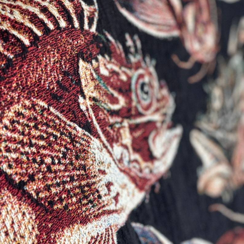 Vintage fish wall art. Close up of vintage fish woven throw blanket.