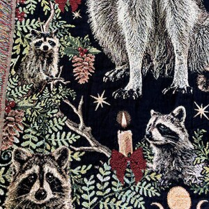 The ideal hygge gift for raccoon lovers, this raccoon blanket is adorable. Several cute raccoons are woven into a black background surrounded by greenery, mistletoe, holly berries, pine cones, Christmas candles and red bows.