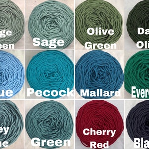 May include: A grid of twelve skeins of cord in various colors, each labeled with white text: Sage Green, Sage, Olive Green, Dark Olive, Blue, Pecock, Mallard, EverGreen, Grey Blue, Green, Cherry Red, and Black. The cord is wound into circular shapes.