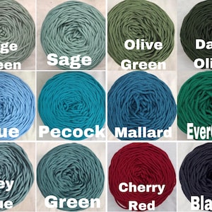 May include: A grid of twelve yarn skeins in various colours including Sage Green, Sage, Olive Green, Dark Olive, Blue, Pecock, Mallard, EverGreen, Grey Blue, Green, Cherry Red, and Black. Each skein is labelled with its corresponding colour name in white text.